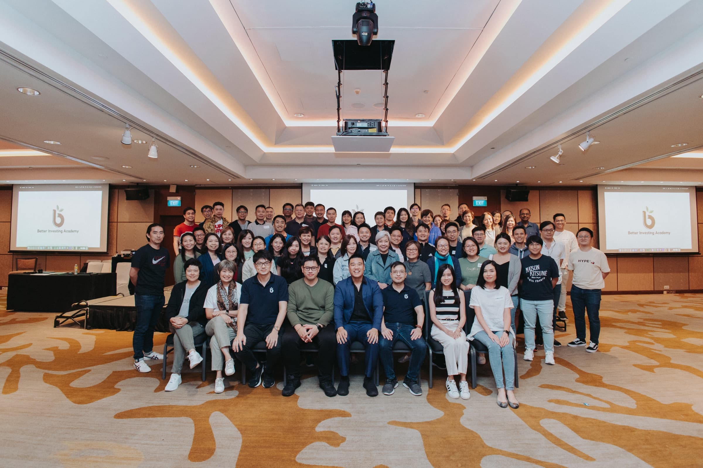 Daniel Lim seated front and centre with members of the Better Investing Academy community at a past live session